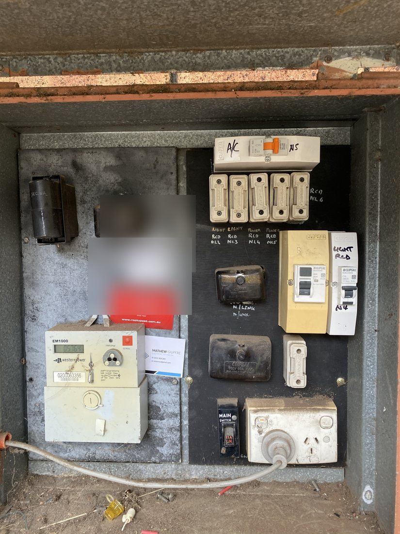 Old Perth switchboard with rewireable fuses on an asbestos panel