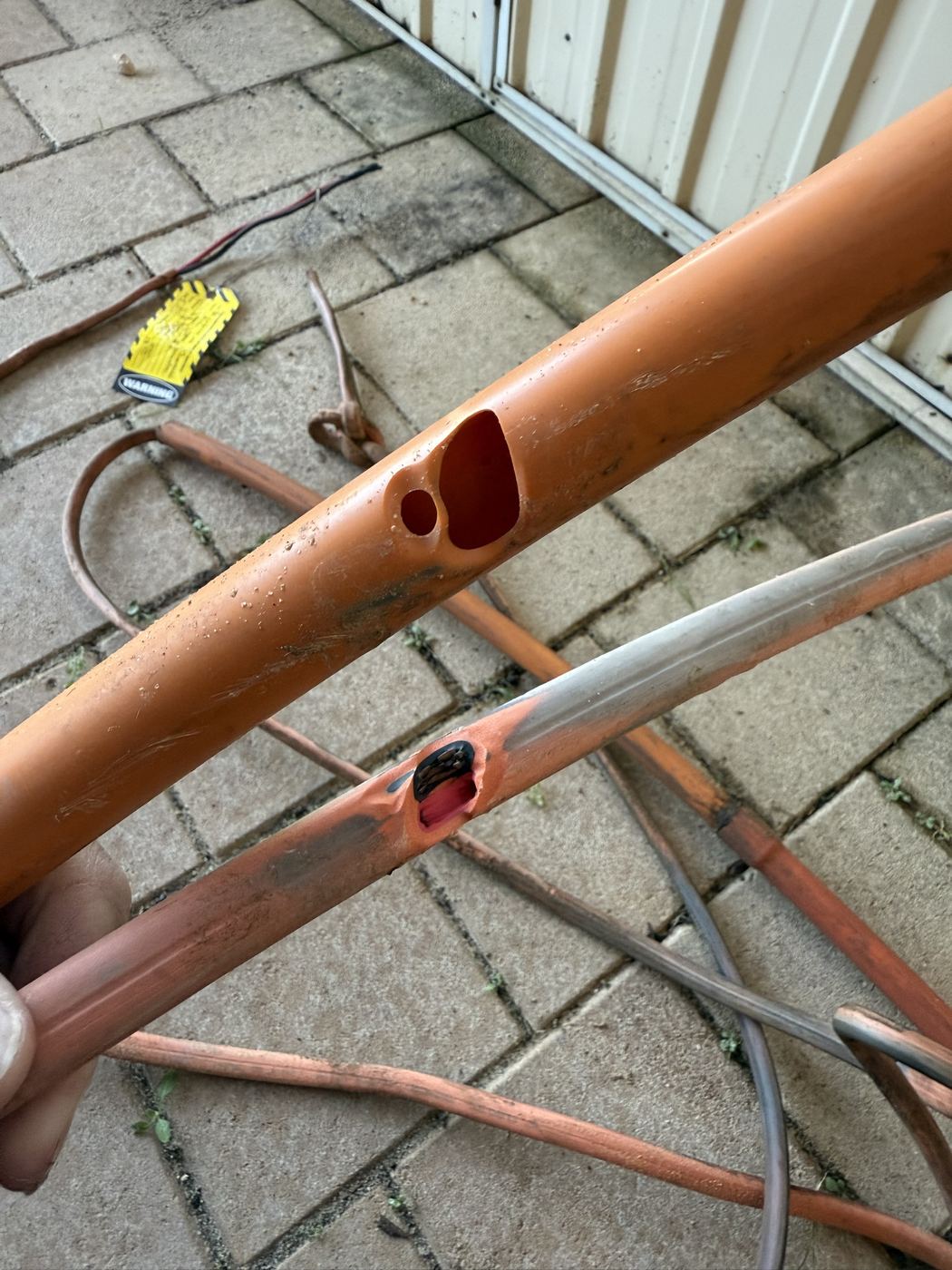 Damaged underground supply cable and conduit dug up during fault finding