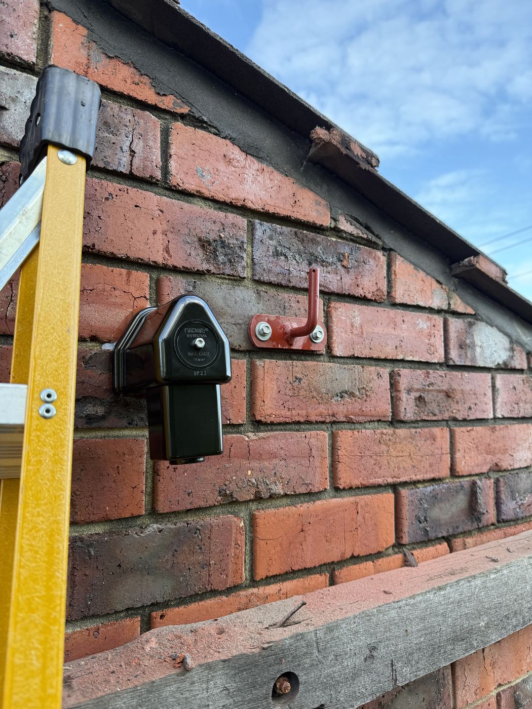 New service connection box and bracket fitted to a brick wall