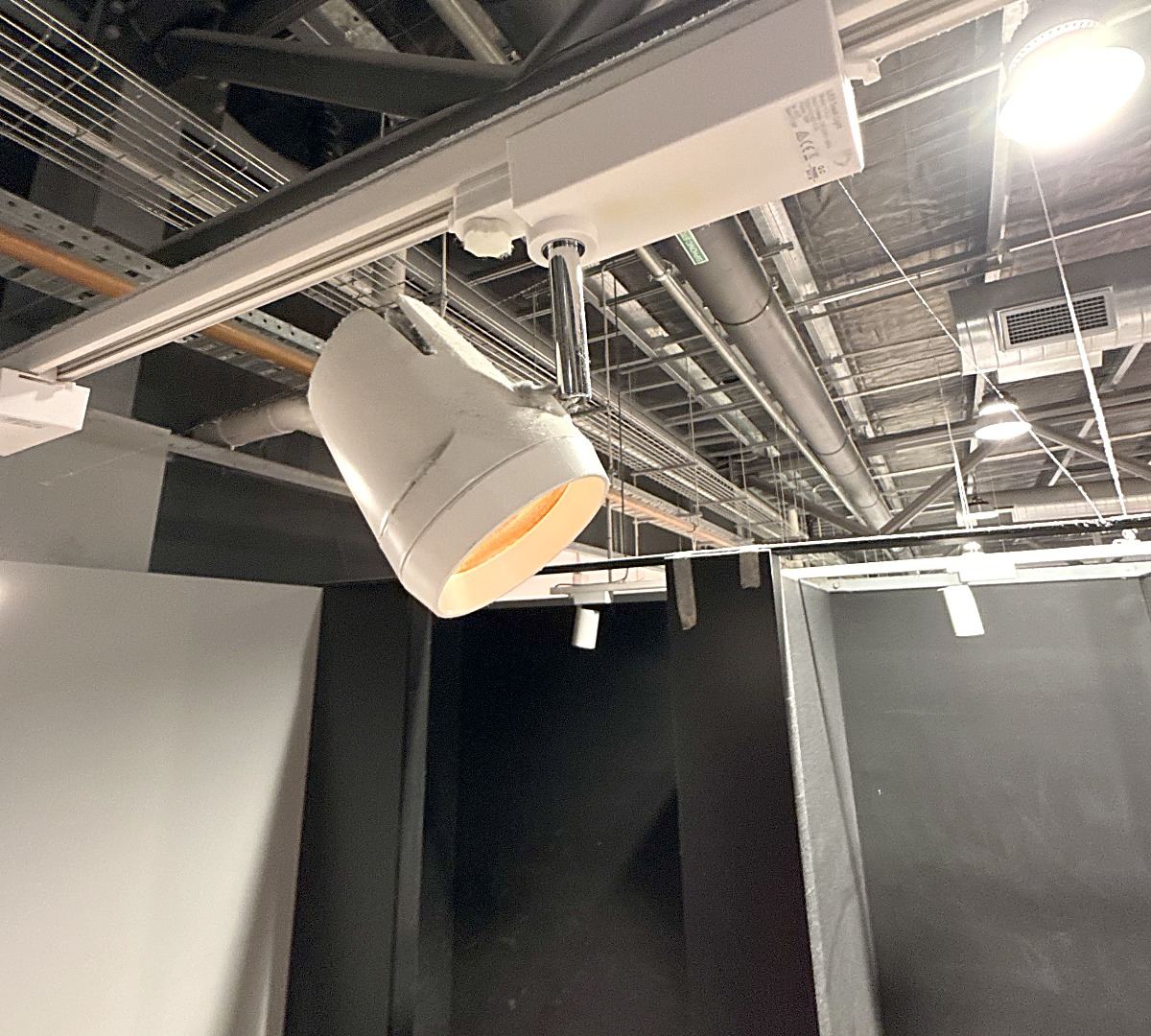 Heat-damaged track light fitting in a shop
