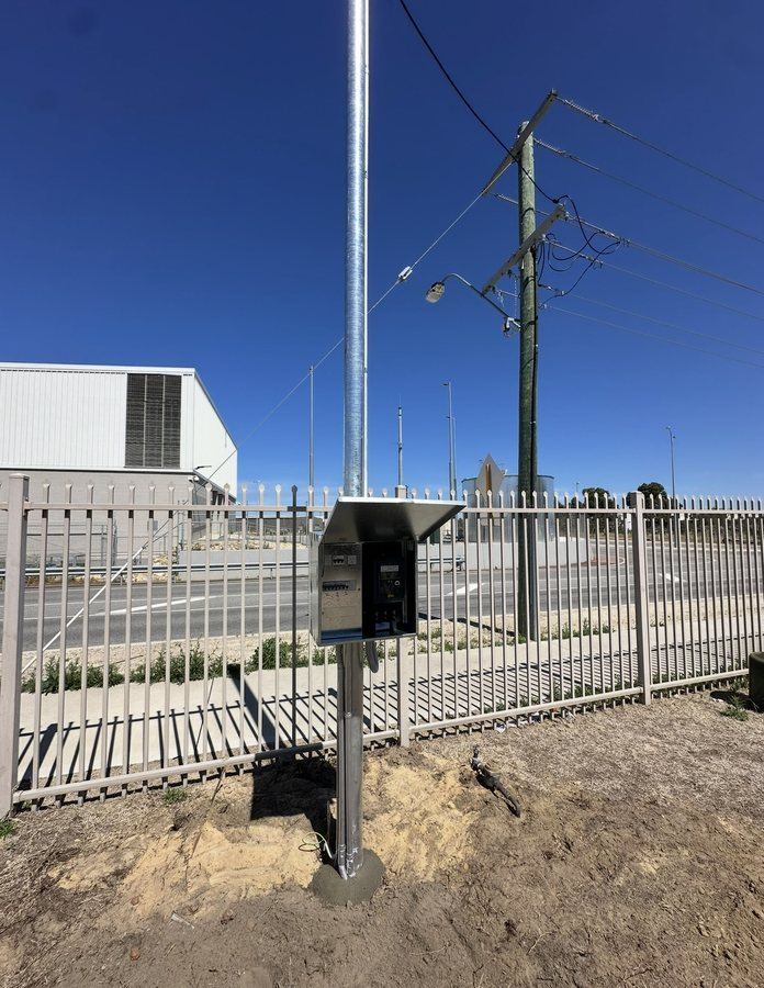 Galvanised consumer pole with metering and service enclosure installed at a Perth commercial site