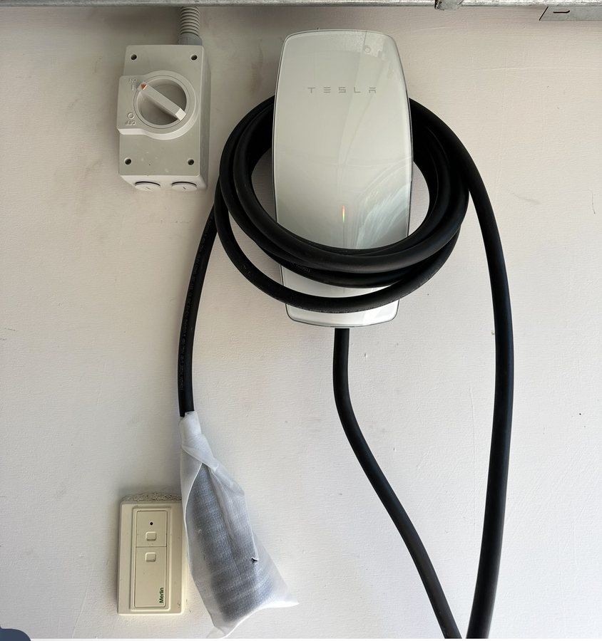 Tesla Wall Connector installed in a Perth garage with a dedicated isolator alongside