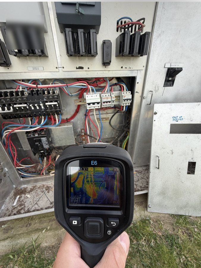 Thermal imaging camera showing a hot spot on a live multi-tenancy switchboard in Perth